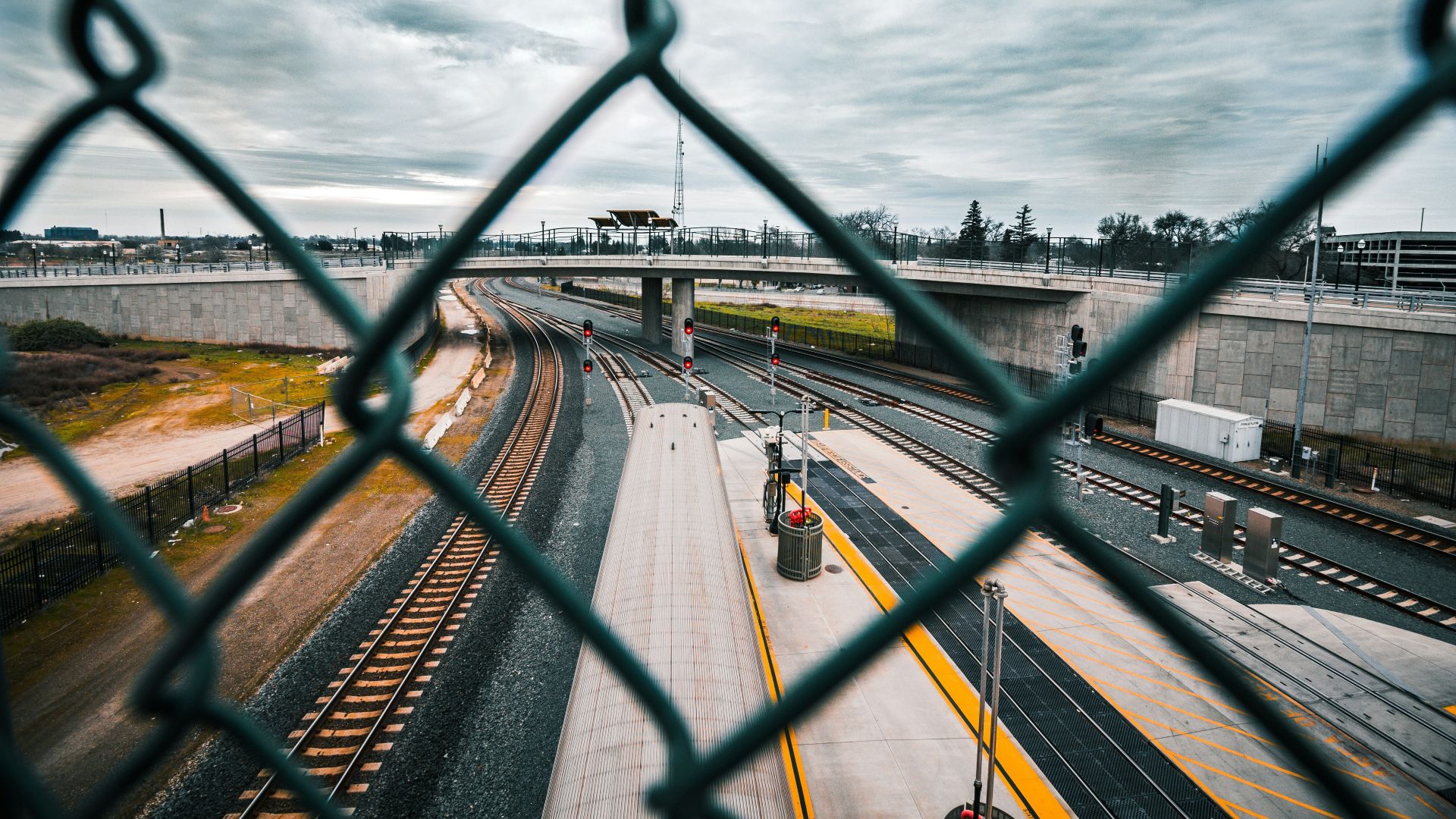 A view of a railway through a chainlink fence