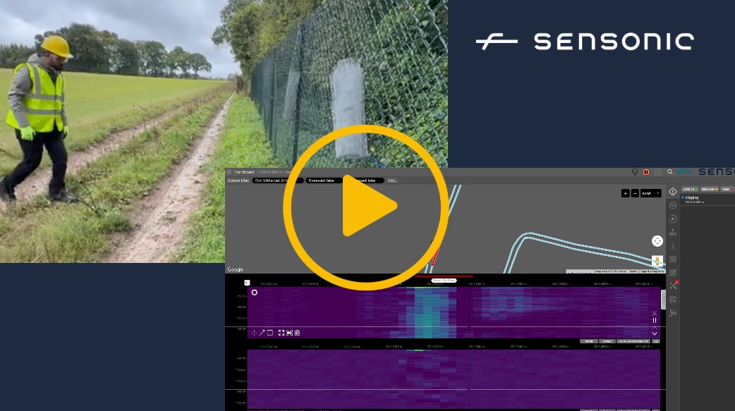 A video thumbnail with a play icon in the centre - The video highlights railway security. A person is climbing and tampering with a fence on the railway. Inset is a graph showing each footstep being detected as a security event. Also inset is a persons face talking, along with subtitles on the screen which read 